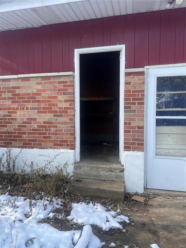 view of snow covered property entrance