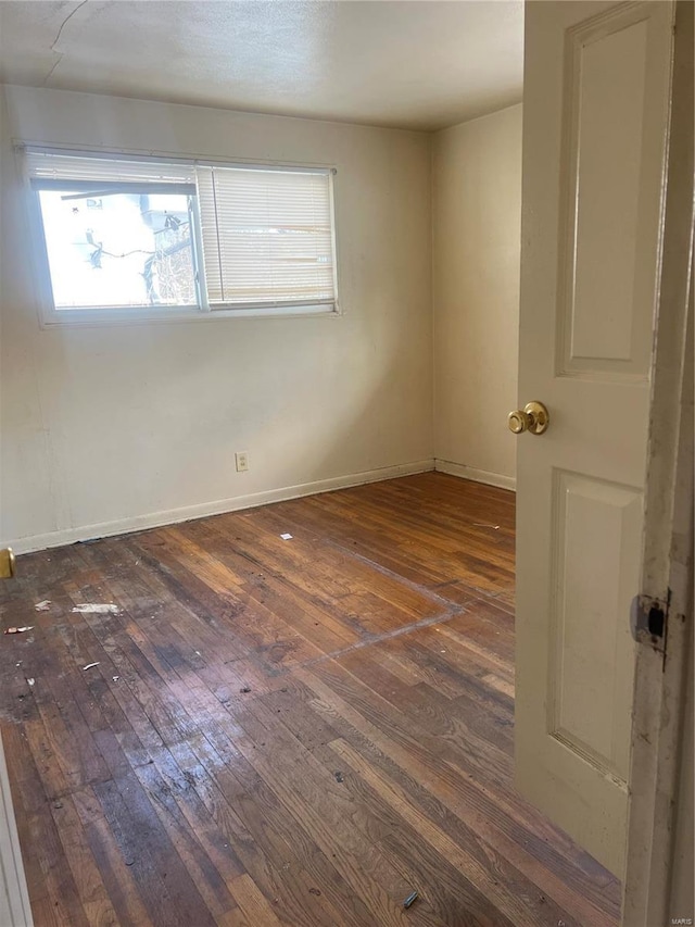 unfurnished room with dark hardwood / wood-style floors