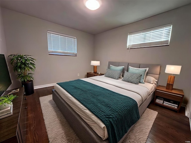 bedroom with wood finished floors and baseboards