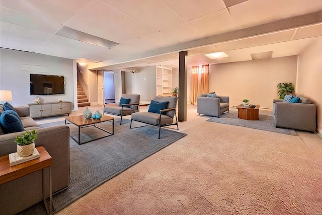 carpeted living room featuring stairway