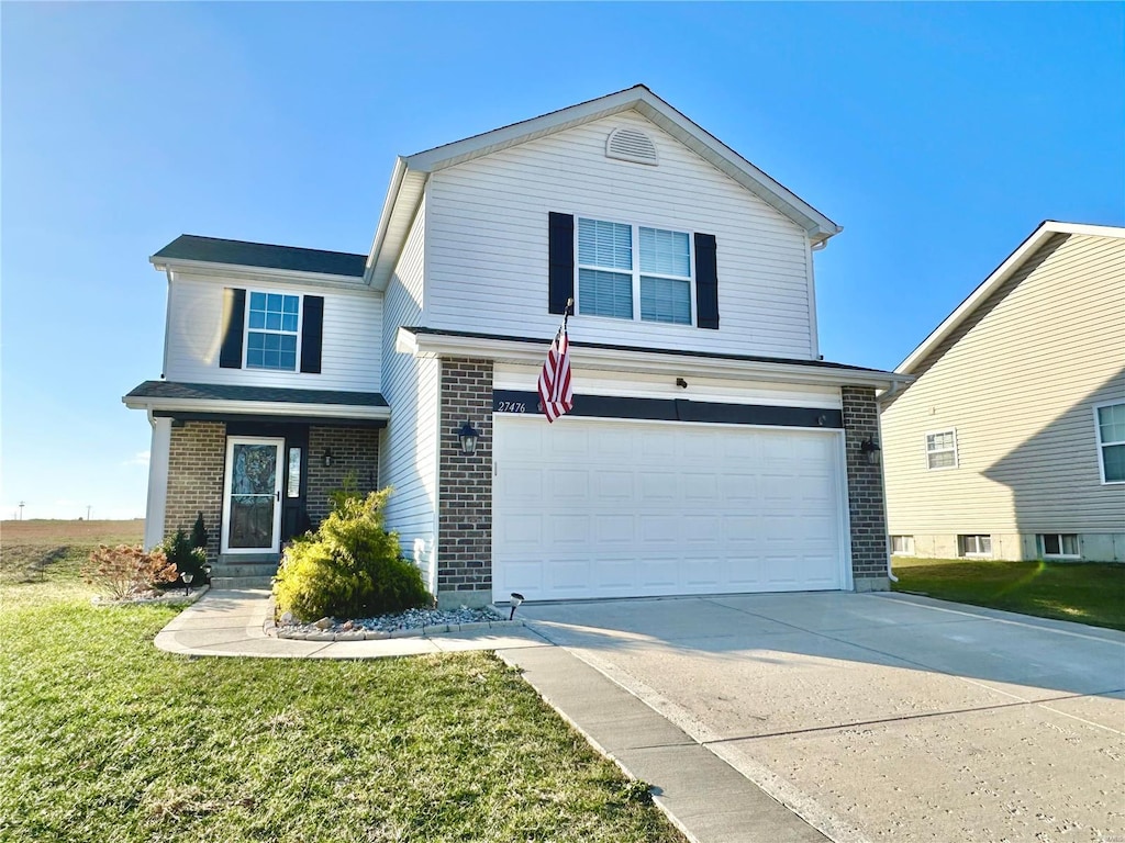 front facade with a front yard and a garage