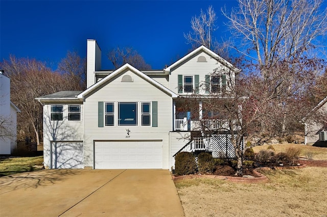 front facade with a garage, a front yard, and covered porch