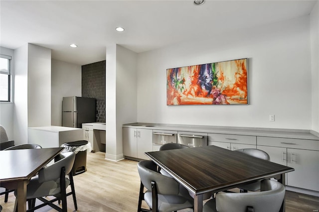 dining space with light hardwood / wood-style flooring