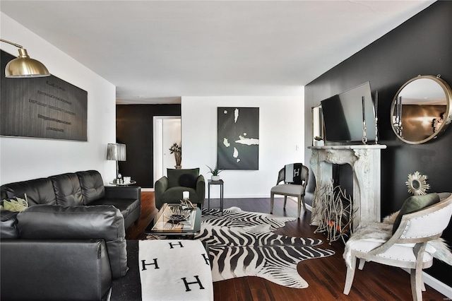 living room featuring hardwood / wood-style flooring and a high end fireplace