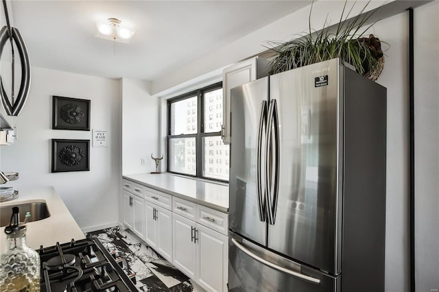 kitchen with white cabinets and stainless steel refrigerator