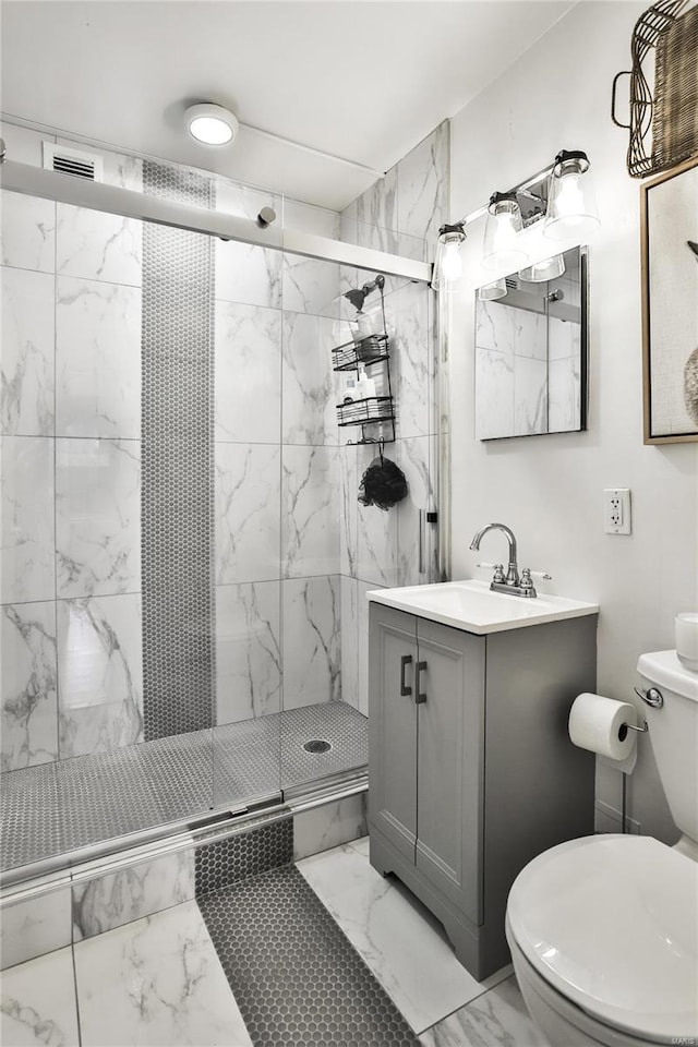 bathroom with an enclosed shower, vanity, and toilet