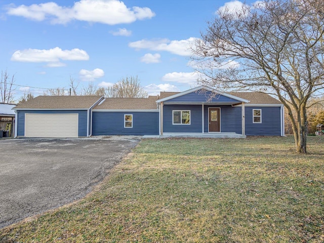 ranch-style home featuring a garage and a front yard