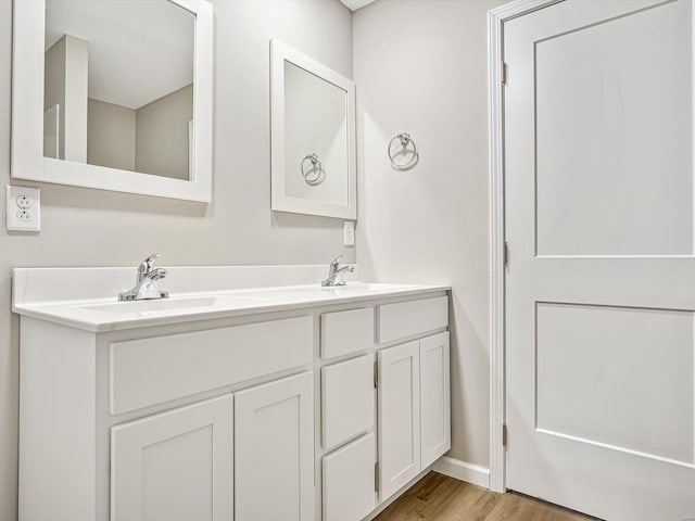 bathroom with vanity and hardwood / wood-style floors