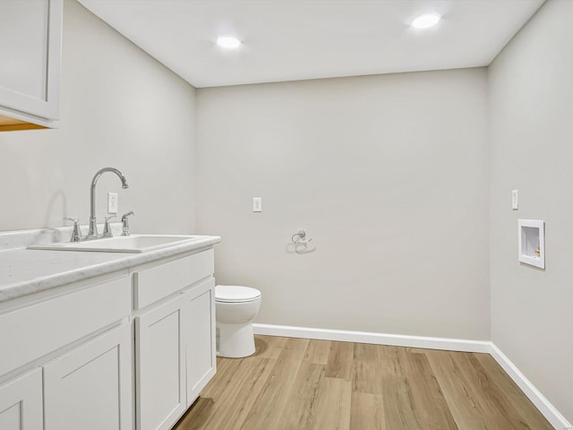 bathroom featuring hardwood / wood-style flooring, toilet, and vanity