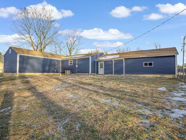 rear view of house featuring central AC