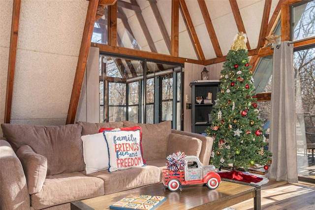 sunroom with vaulted ceiling with beams and a healthy amount of sunlight