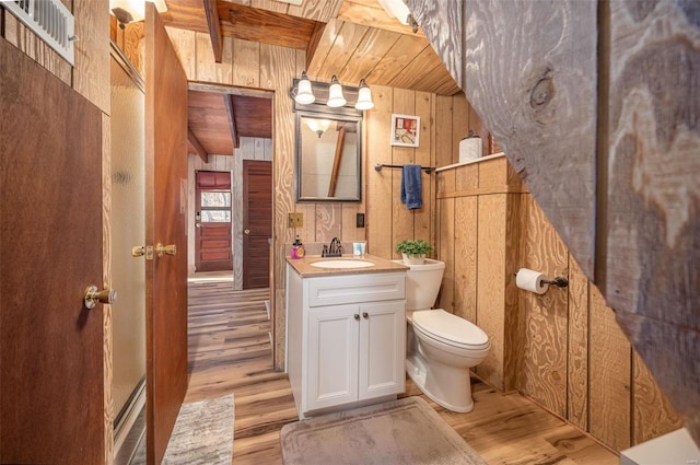 bathroom with wooden ceiling, wood walls, wood-type flooring, toilet, and vanity