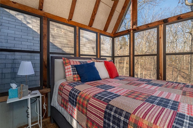 bedroom with lofted ceiling with beams