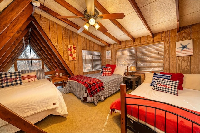 carpeted bedroom with vaulted ceiling with beams, wood walls, and ceiling fan