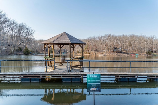 view of dock with a gazebo and a water view