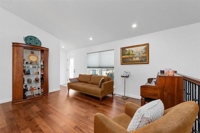 living room featuring vaulted ceiling and hardwood / wood-style flooring