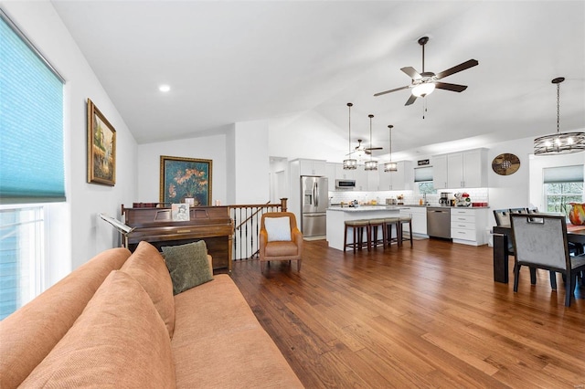 living room with wood-type flooring, ceiling fan, and lofted ceiling