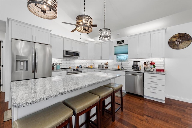 kitchen featuring sink, white cabinetry, dark wood-type flooring, and appliances with stainless steel finishes