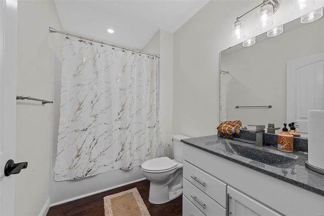 full bathroom with hardwood / wood-style floors, vanity, shower / bath combination with curtain, and toilet