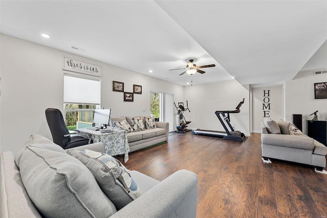 living room featuring ceiling fan and dark hardwood / wood-style floors