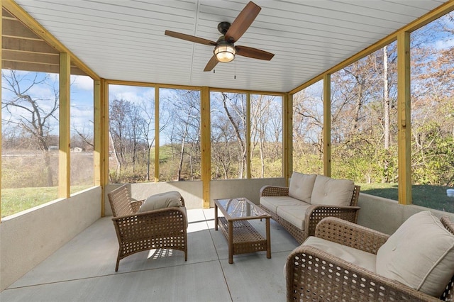 sunroom with ceiling fan and wooden ceiling