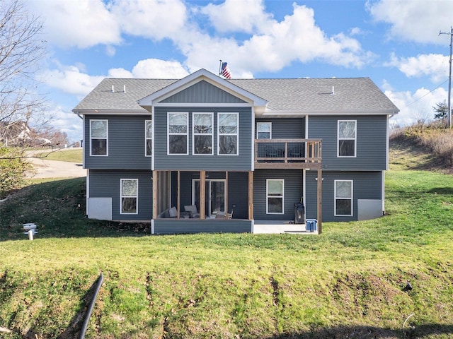 rear view of property featuring a yard