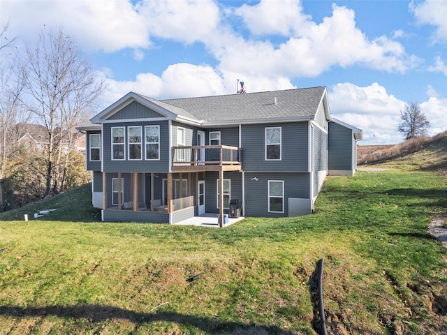 back of house featuring a patio area and a lawn