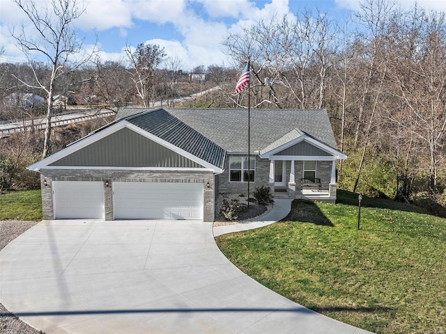 view of front of house with covered porch, a garage, and a front yard