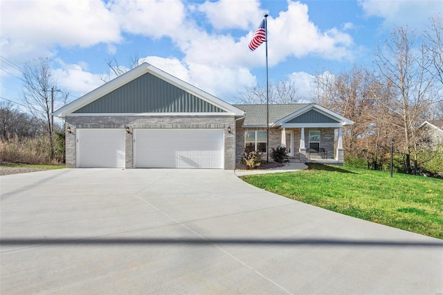 view of front of house with a front lawn, a porch, and a garage