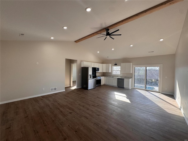 unfurnished living room with dark wood finished floors, beamed ceiling, baseboards, and visible vents