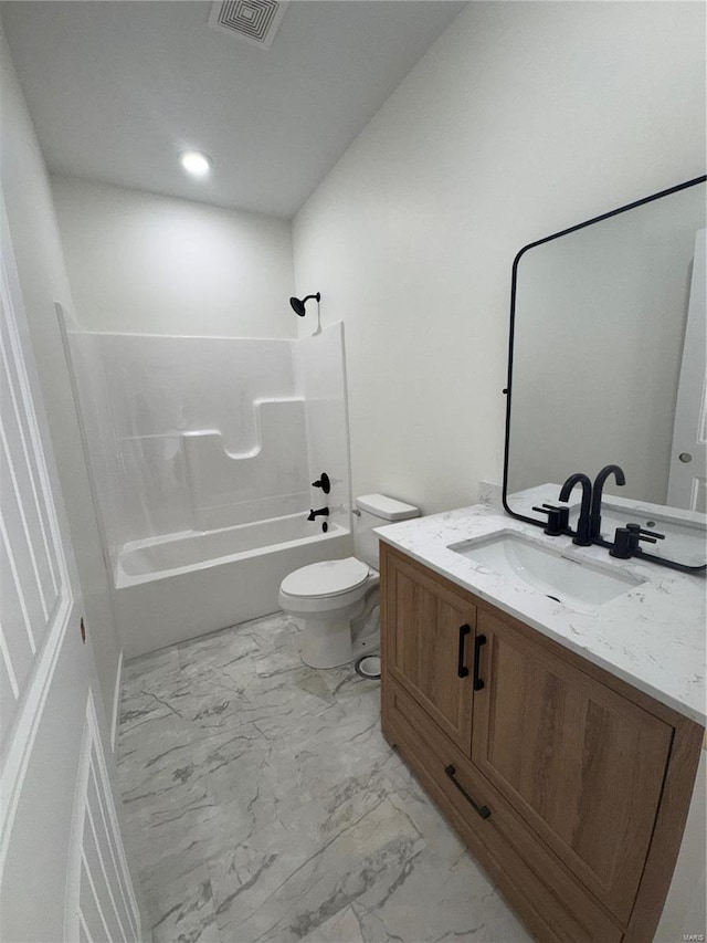 full bathroom featuring visible vents, toilet, marble finish floor, washtub / shower combination, and vanity