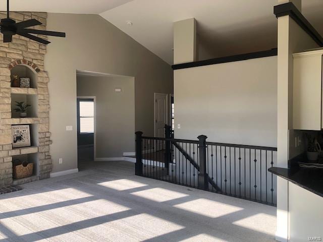 interior space featuring ceiling fan and high vaulted ceiling