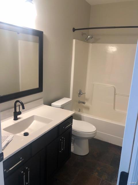 full bathroom featuring shower / washtub combination, vanity, and toilet