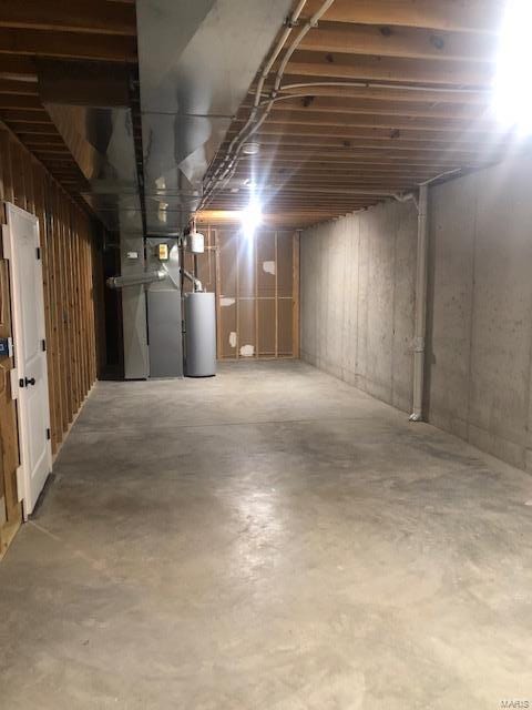 basement featuring heating unit and gas water heater