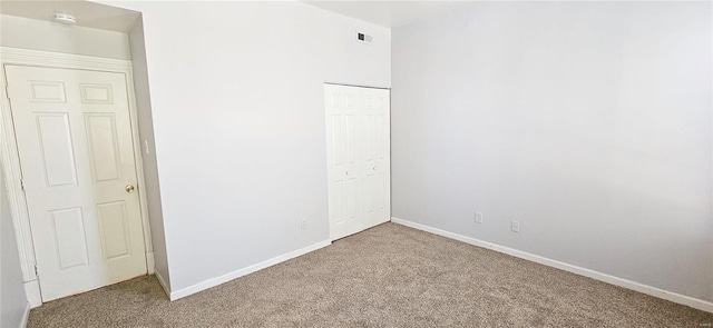 unfurnished bedroom featuring a closet and carpet floors