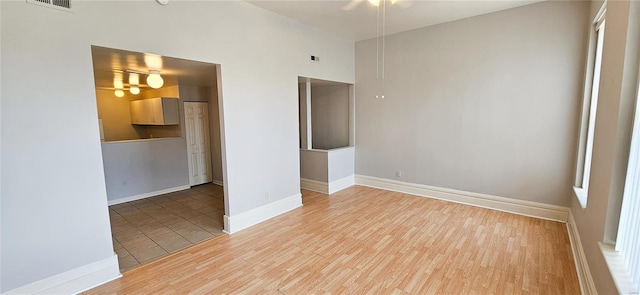 spare room featuring ceiling fan and light hardwood / wood-style flooring