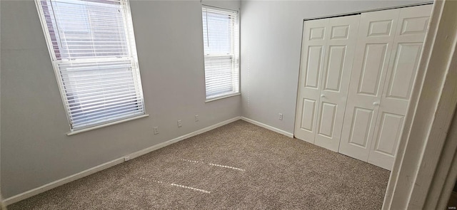 unfurnished bedroom with a closet and carpet flooring