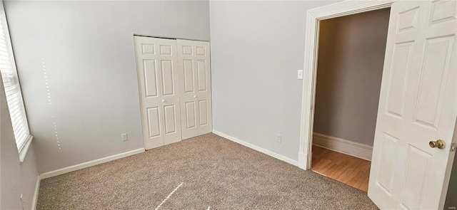 unfurnished bedroom featuring a closet and carpet flooring