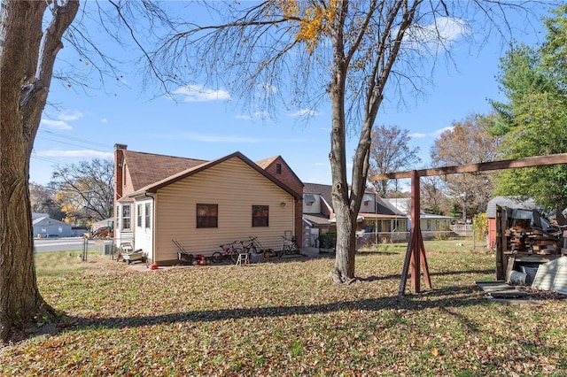 view of side of home with a yard