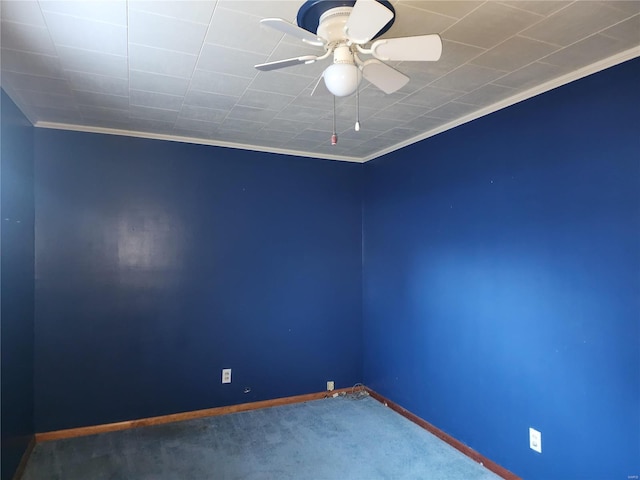 carpeted spare room featuring ceiling fan and crown molding