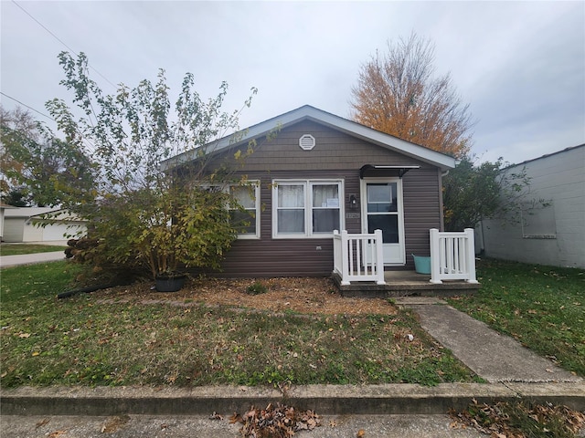 bungalow-style house with a front lawn