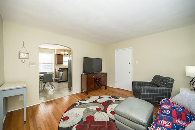 living room featuring light hardwood / wood-style floors and a notable chandelier