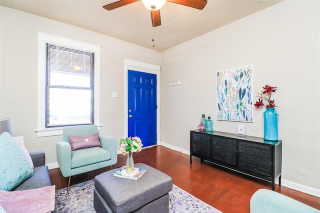 living room featuring ceiling fan and dark hardwood / wood-style flooring