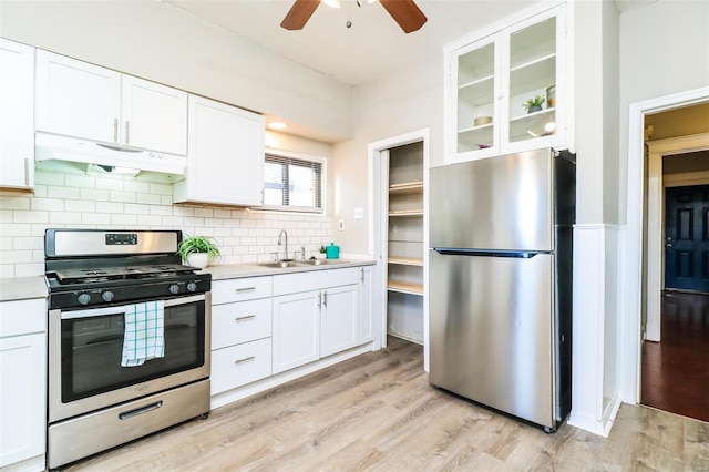 kitchen with white cabinets, appliances with stainless steel finishes, light hardwood / wood-style flooring, and sink