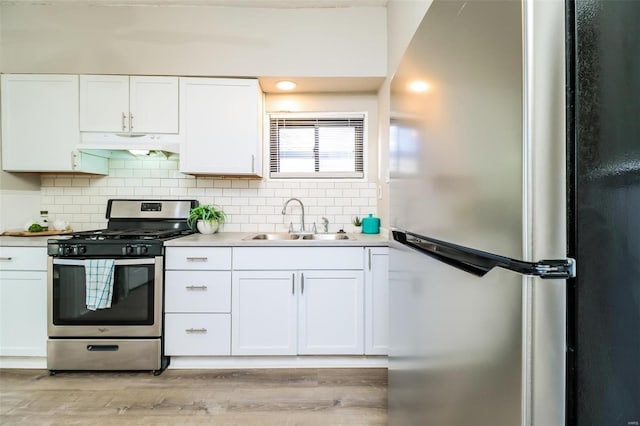 kitchen featuring white cabinets, sink, light wood-type flooring, and stainless steel appliances