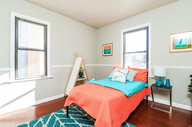 bedroom with dark hardwood / wood-style floors