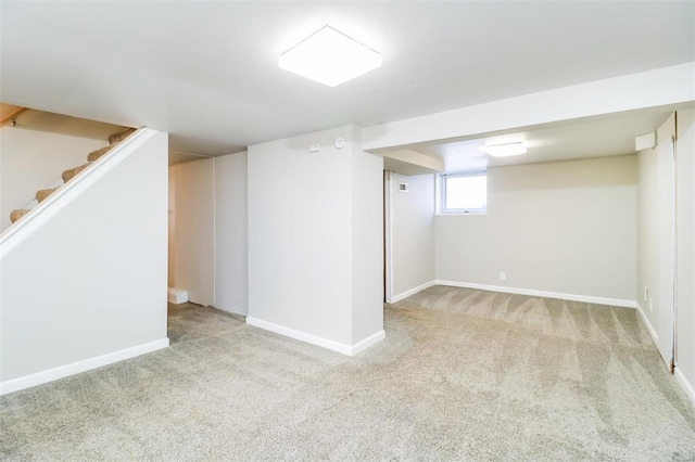 basement featuring light colored carpet