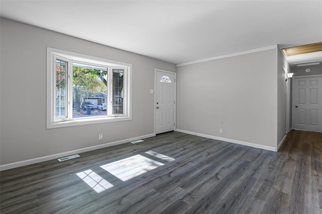 foyer entrance with crown molding and dark wood-type flooring