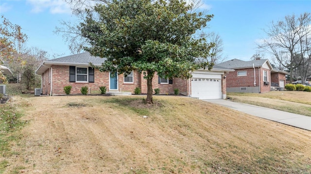 ranch-style home with cooling unit, a garage, and a front yard