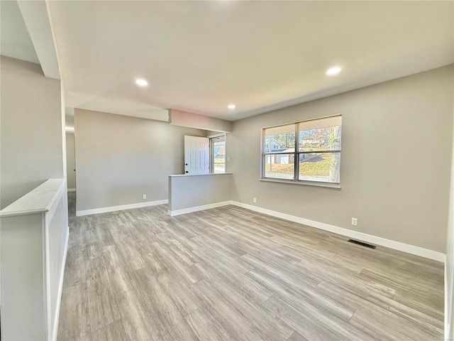 spare room with light wood-type flooring